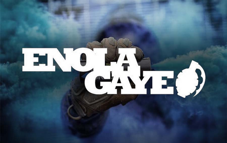 Enola Gaye smoke grenade held by gloved hand in blue smoke background reseller enola gaye taginn canada