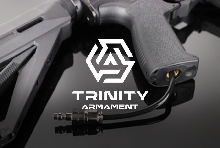 Close-up of a firearm accessory featuring the Trinity Armament Canada logo on a sleek surface