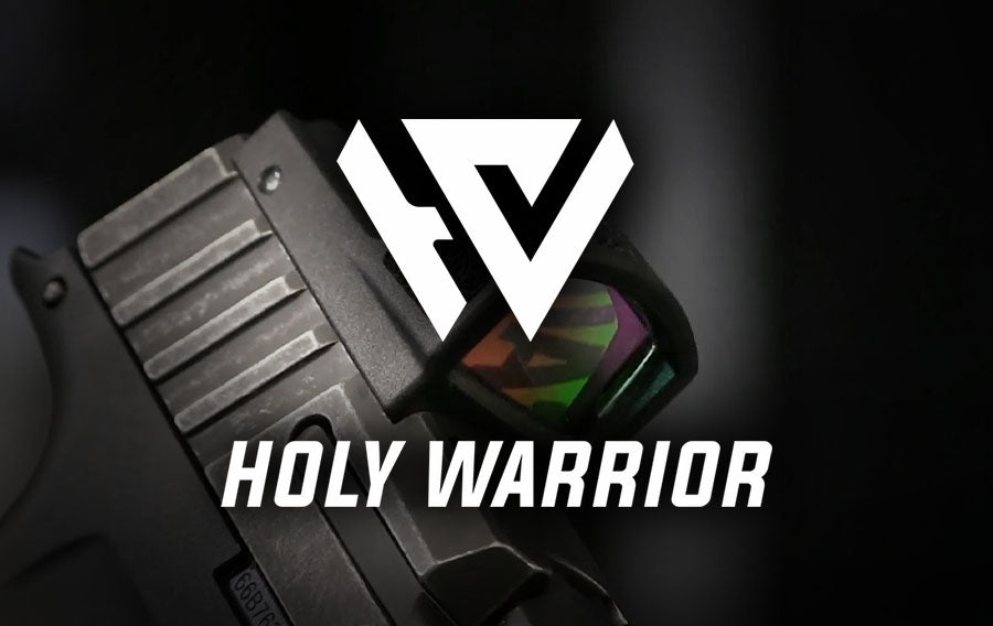 holy warrior Airsoft canada logo displayed over close up handgun slide with red dot sight and green reflective lens