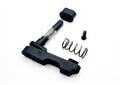A black metal mechanical component, likely a firearm trigger assembly, shown disassembled with its spring, screw, and cap on a white background.