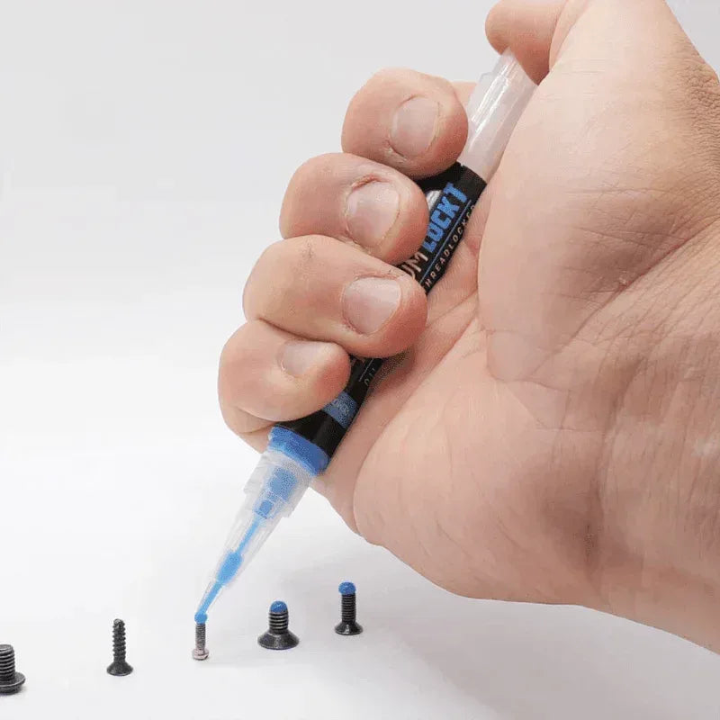 4UANTUM LOCK THREAD LOCKER applicator in hand, applying to screws for secure fastening
