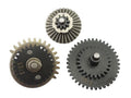 Three metal mechanical gears in different sizes and finishes, including one silver-toned gear and two black/gray gears with toothed edges, shown on a plain white background.