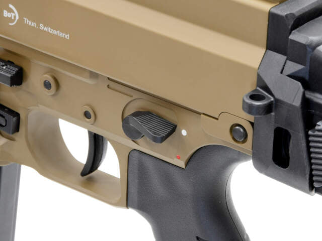 Close-up of ARCHWICK B&T airsoft gbbr showing the selector switch and textured grip