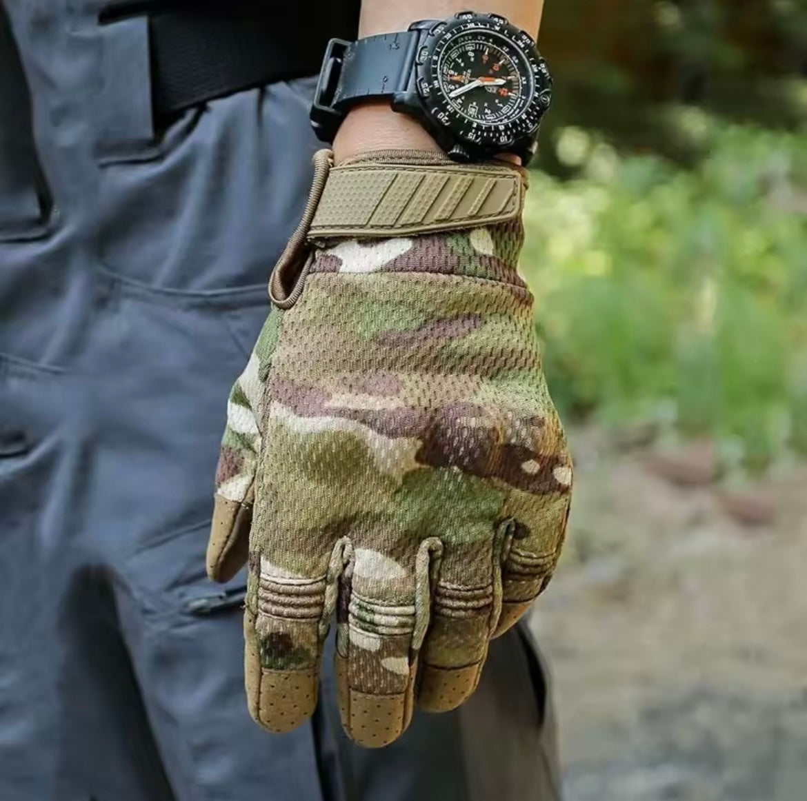 Camo-patterned airsoft glove designed for tactical activities with breathable mesh and reinforced grip