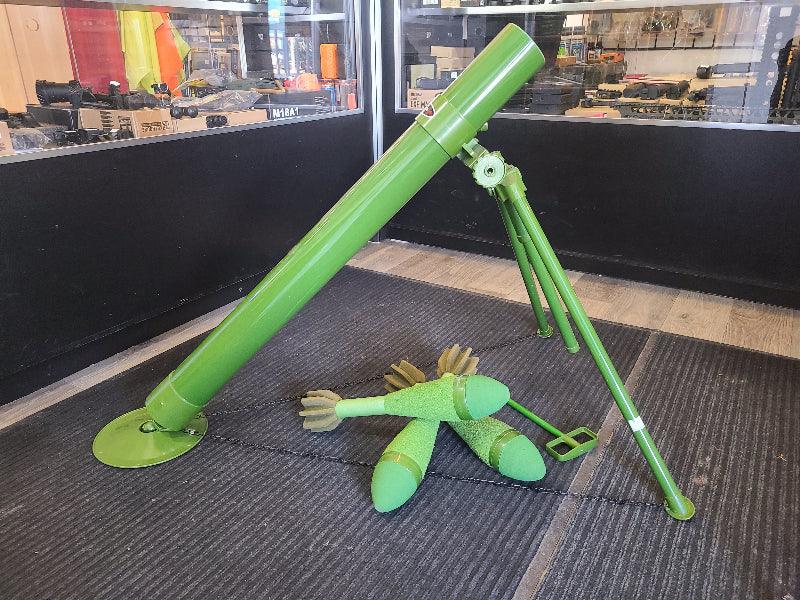 Green District Airsoft airsoft mortar with launch tube and multiple practice grenades on display