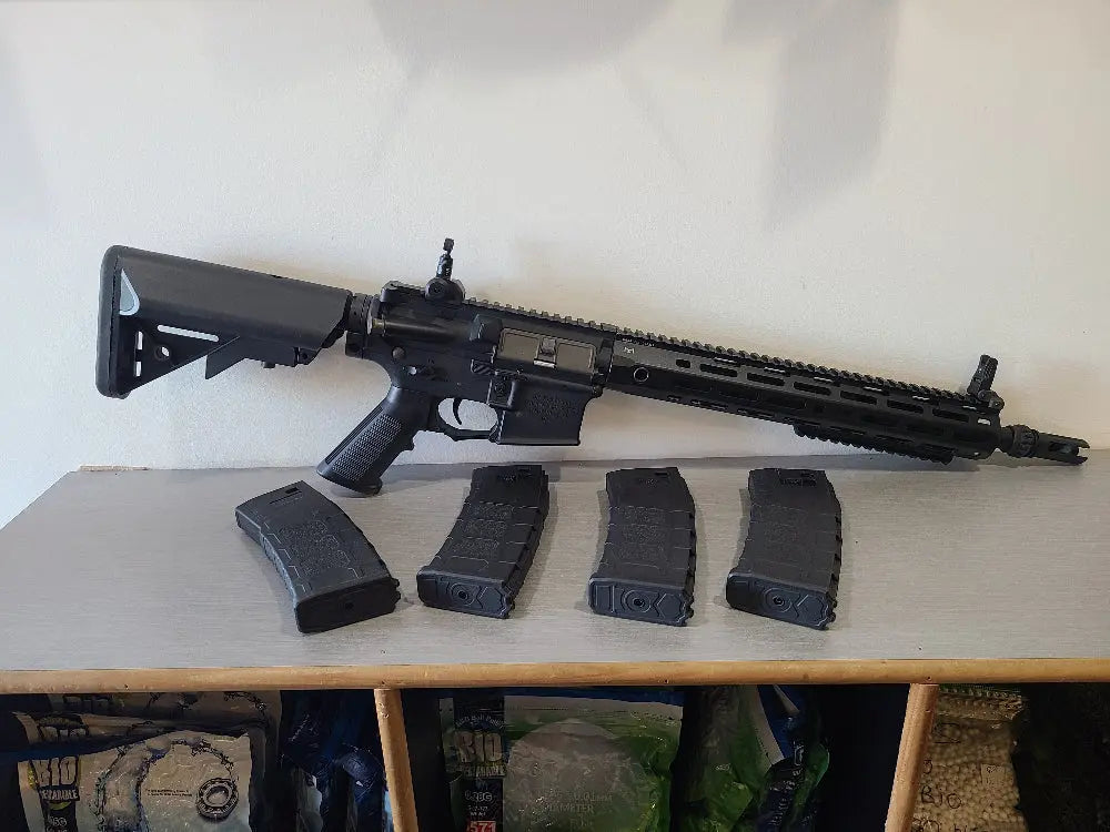 G&G AEG Airsoft rifle displayed with four black magazines for airsoft use