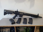 G&G AEG Airsoft rifle displayed with four black magazines for airsoft use