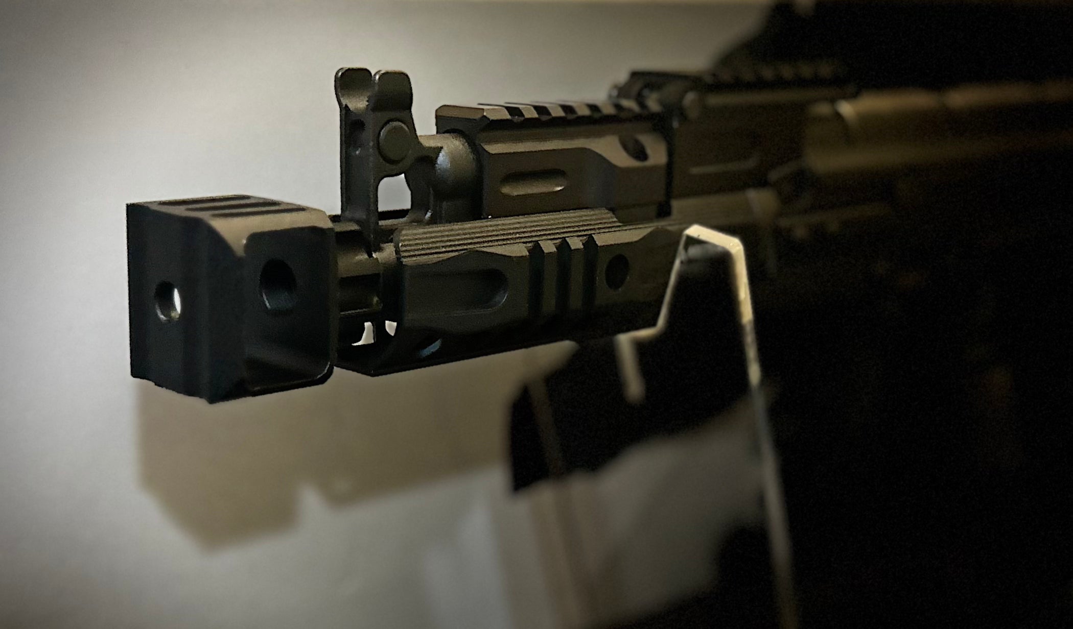 Close-up of the ARCTURUS AK74U CUSTOM showcasing detailed rail system and muzzle device