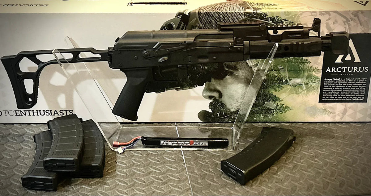 ARCTURUS AK74U CUSTOM airsoft replica with adjustable stock and multiple magazines displayed on clear stand
