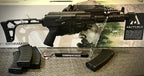 ARCTURUS AK74U CUSTOM airsoft replica with adjustable stock and multiple magazines displayed on clear stand