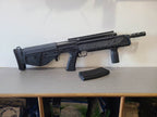 ARES airsoft gun with tactical design on a shelf next to a magazine