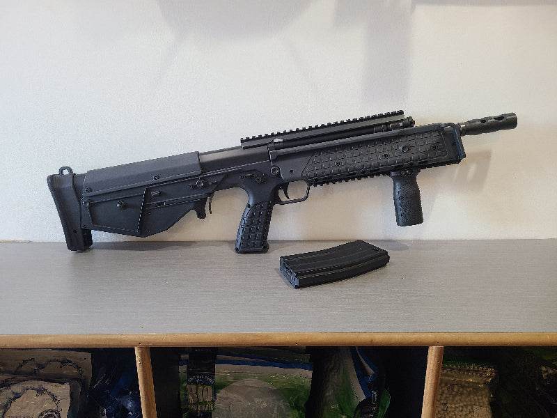 ARES airsoft gun with tactical design on a shelf next to a magazine