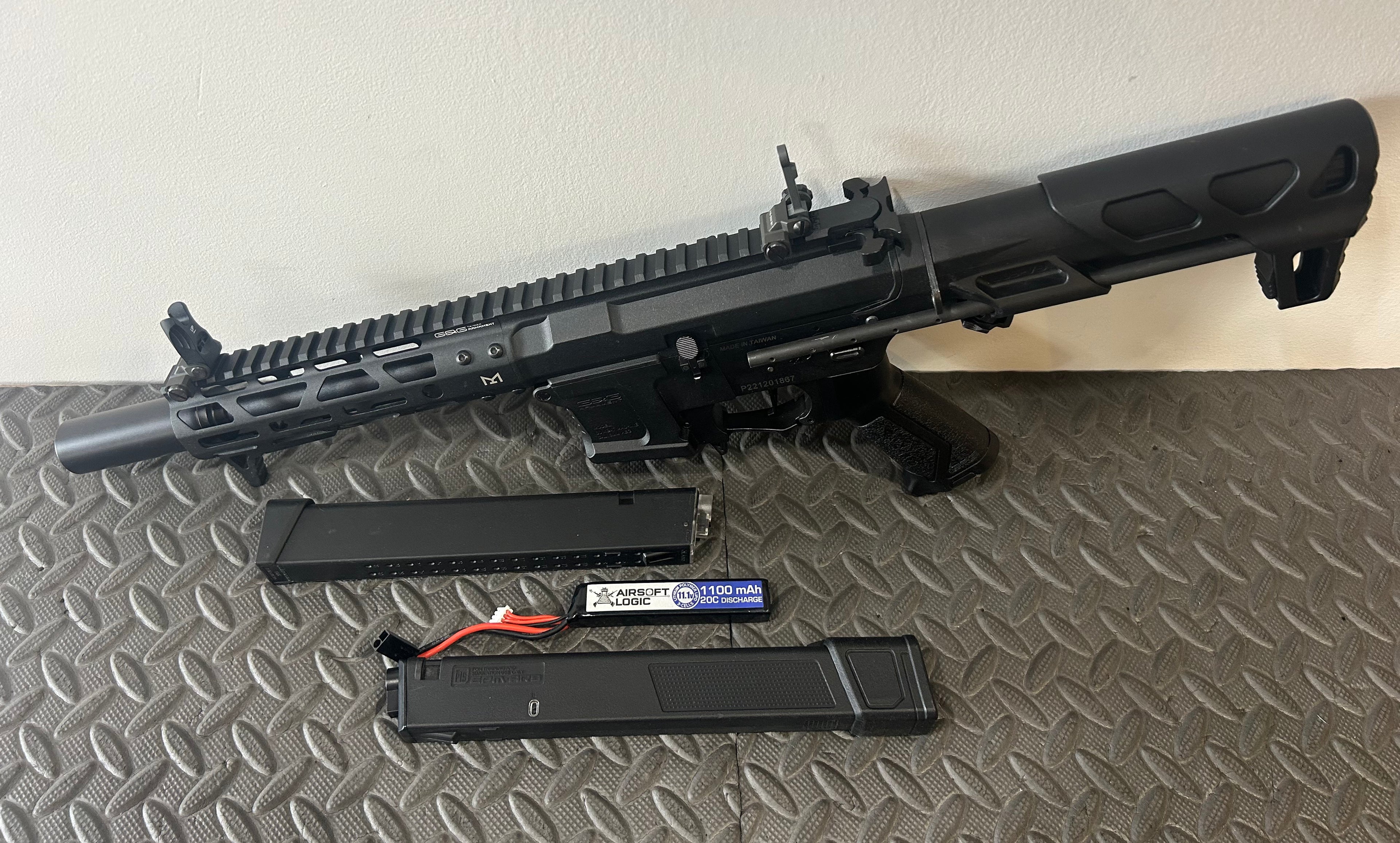 G&G AEG ARP9 airsoft rifle with two magazines and battery on textured background