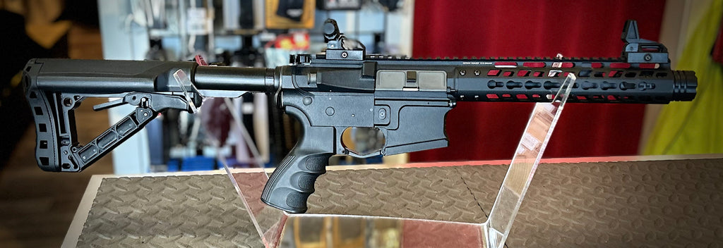 DISTRICT AIRSOFT AEG wild hog 9 black tactical airsoft rifle with collapsible stock and rail handguard on display