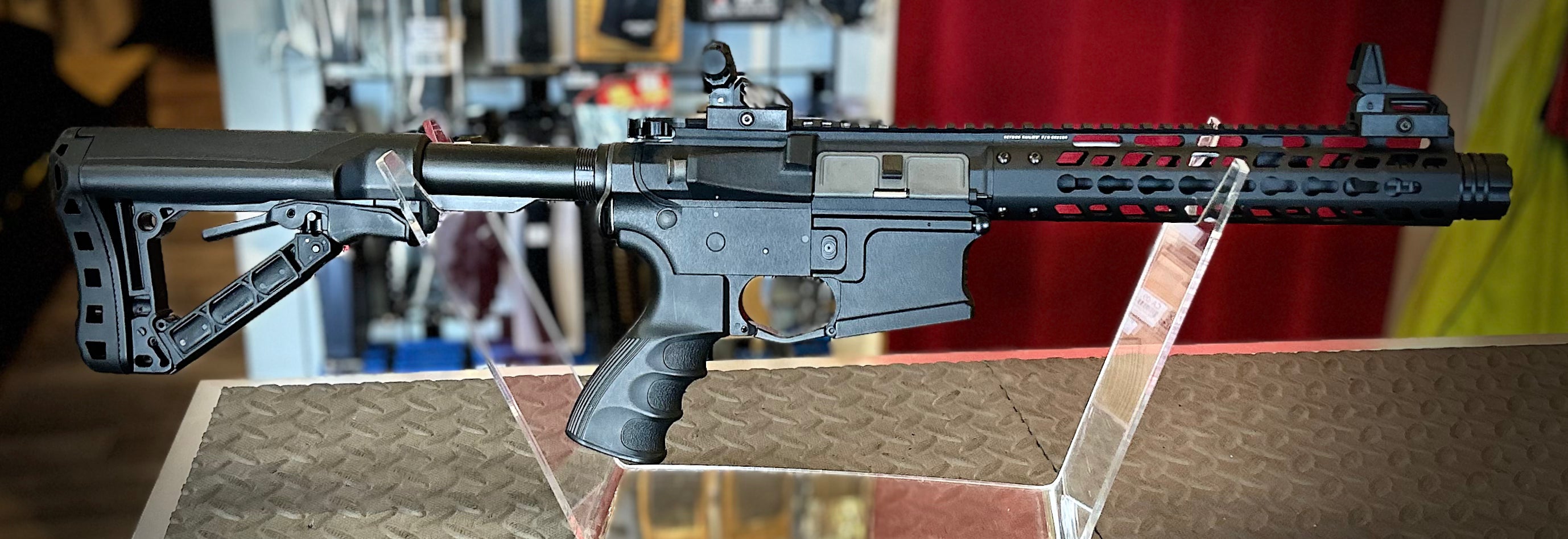 DISTRICT AIRSOFT AEG wild hog 9 black tactical airsoft rifle with collapsible stock and rail handguard on display