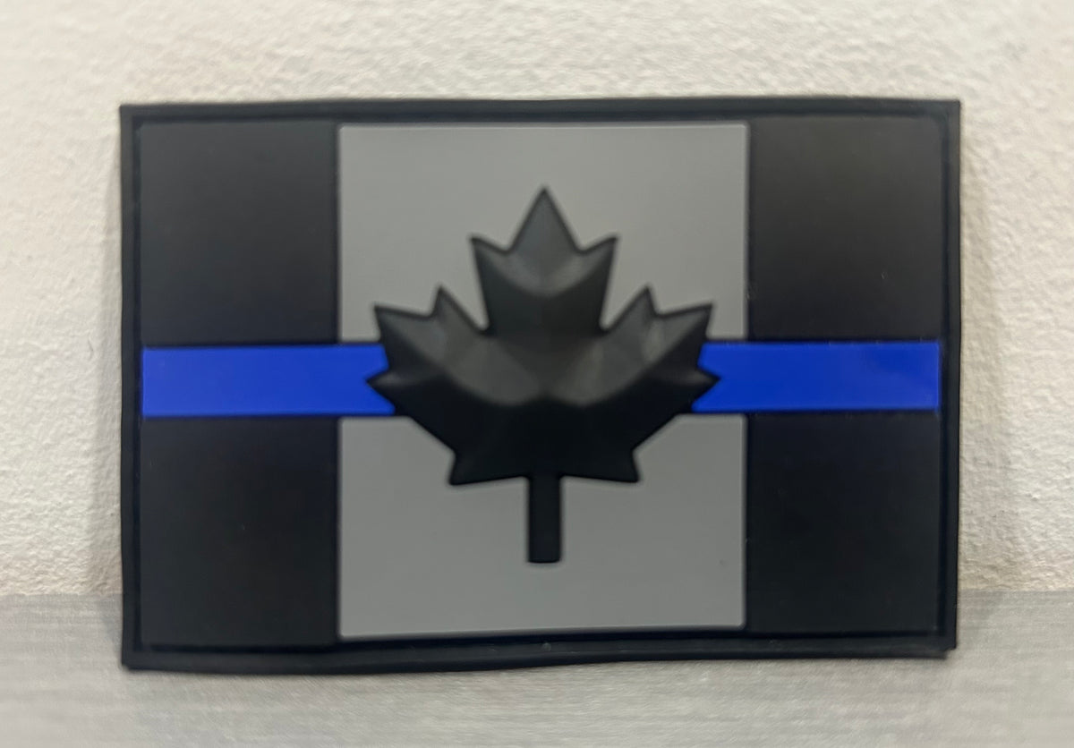 Canada PVC patch in black and gray featuring a stylized maple leaf and blue stripe
