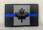 Canada PVC patch in black and gray featuring a stylized maple leaf and blue stripe