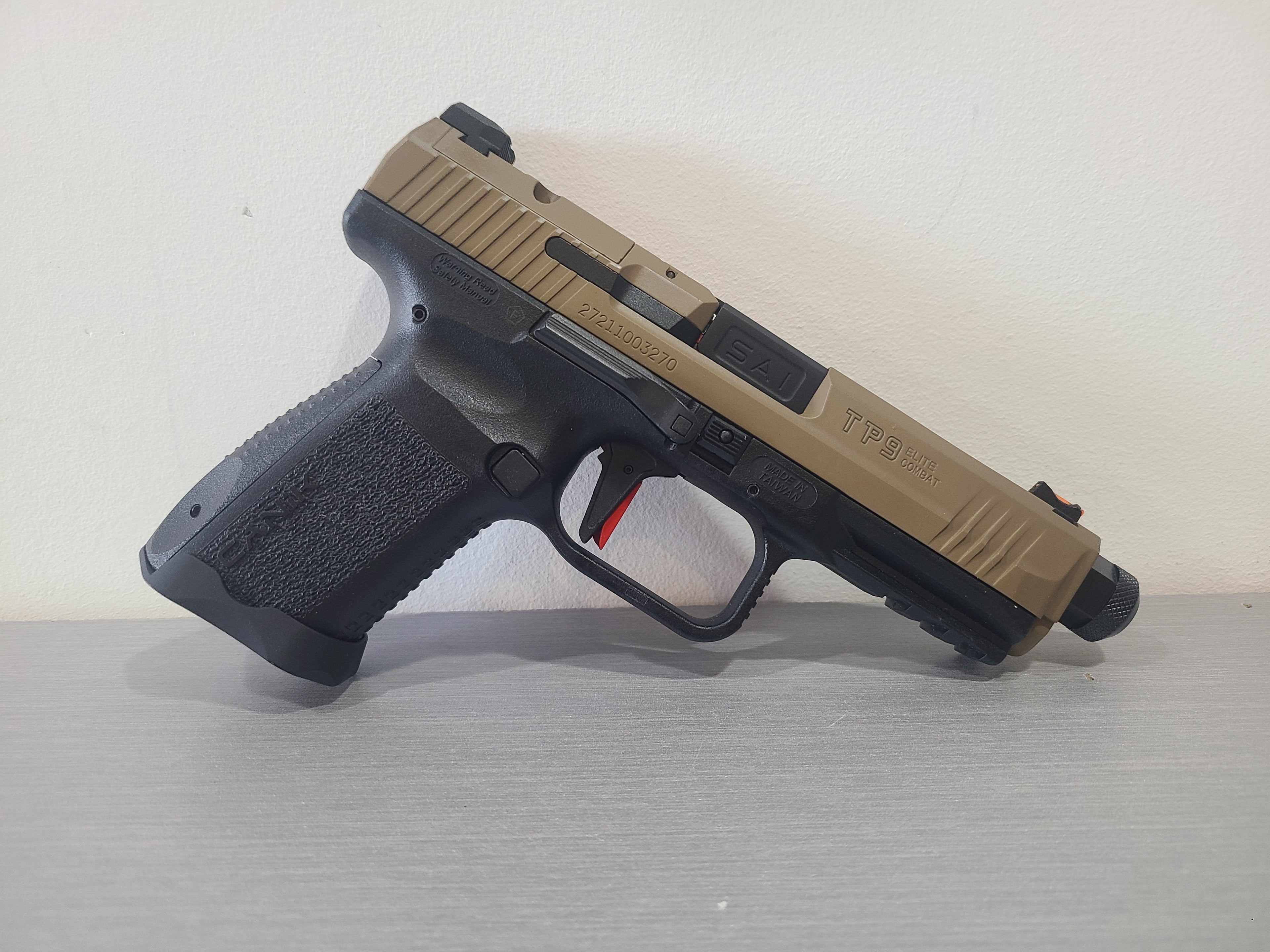 CYBERGUN CANIK TP9 TAN GBB AIRSOFT pistol with tan slide and black textured grip on gray surface