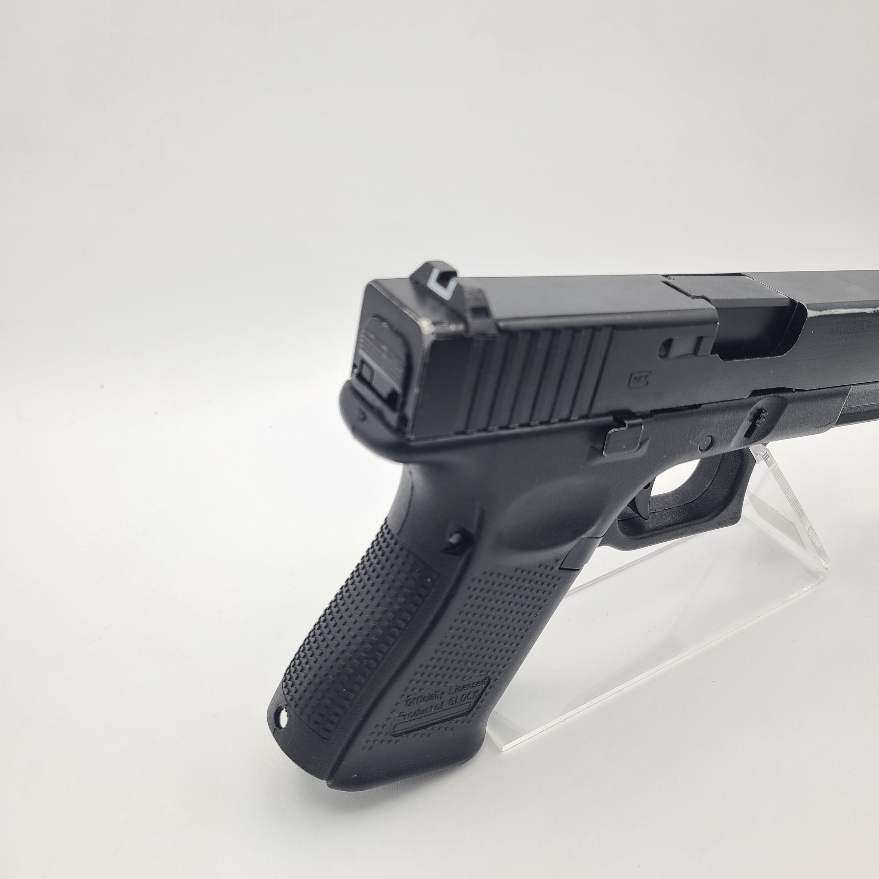 E&C G19 airsoft pistol with textured grip and tactical sights for realistic airsoft gameplay