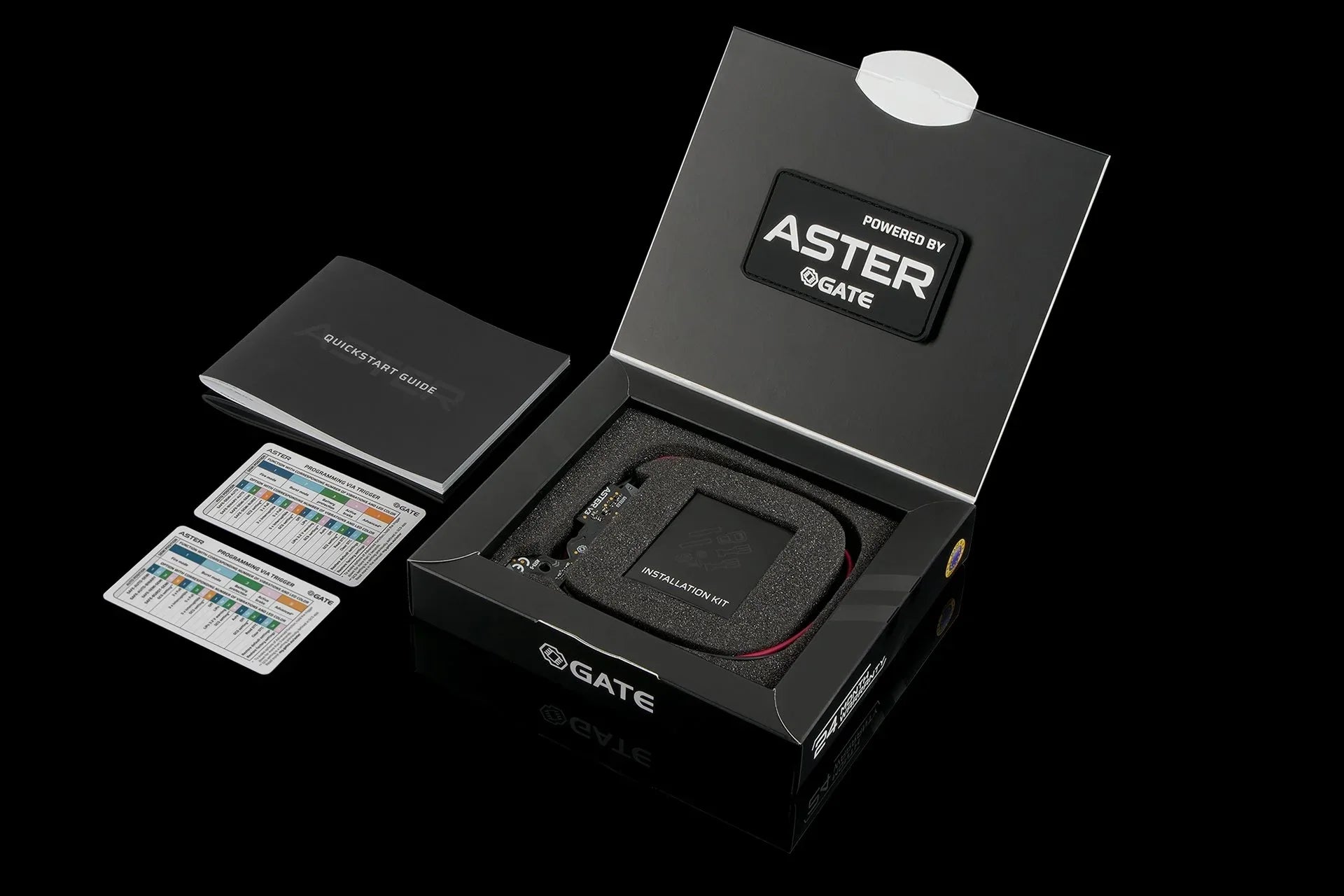 GATE ASTER v3 product packaging displayed with contents, including manuals and accessories.