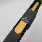 Close-up of Army Armament Glock A34 airsoft pistol showcasing the sleek design and gold magazine