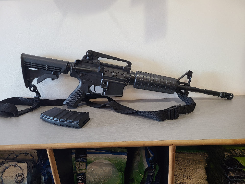 ICS airsoft AEG rifle with adjustable stock and magazine on display