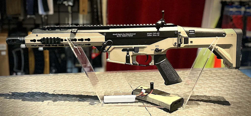 ICS CXP APE TWO TONE AIRSOFT Rifle displayed on a stand with clear acrylic supports