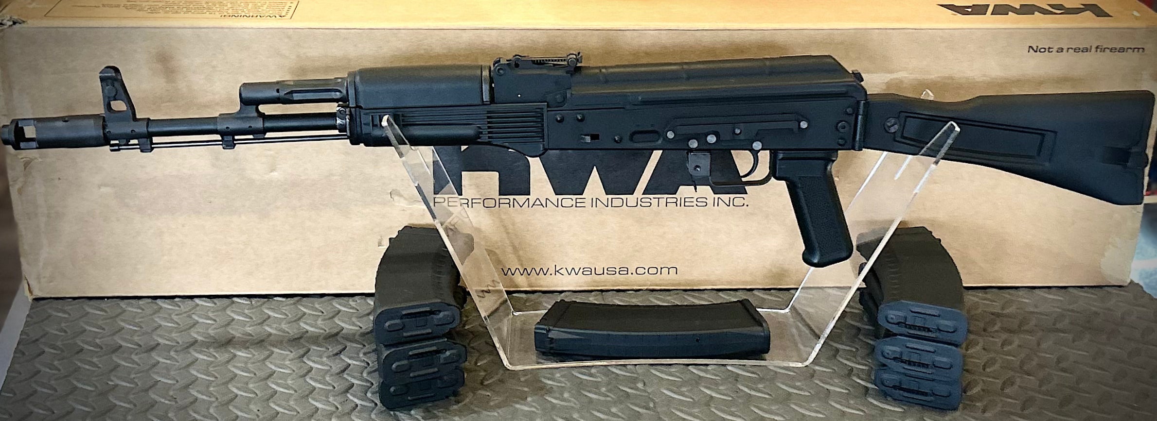 KWA AK 74M Airsoft Gun on Display with Transparent Stand and Magazine Rest