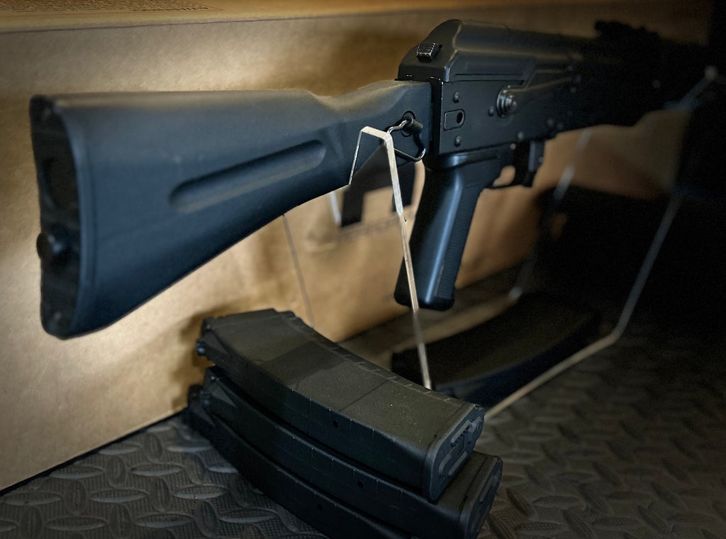 KWA AK 74M Airsoft Rifle with sleek black design and tactical magazines displayed