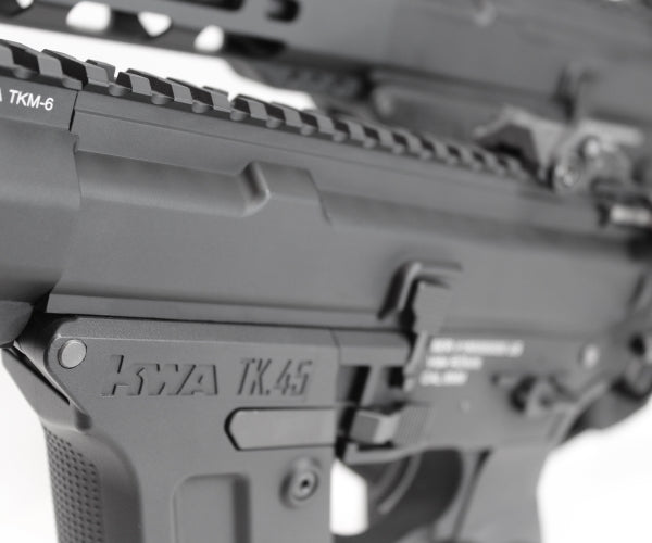 Close up black AEG lower receiver KWA RONIN TK45 airsoft gun showing textured grip and rail details