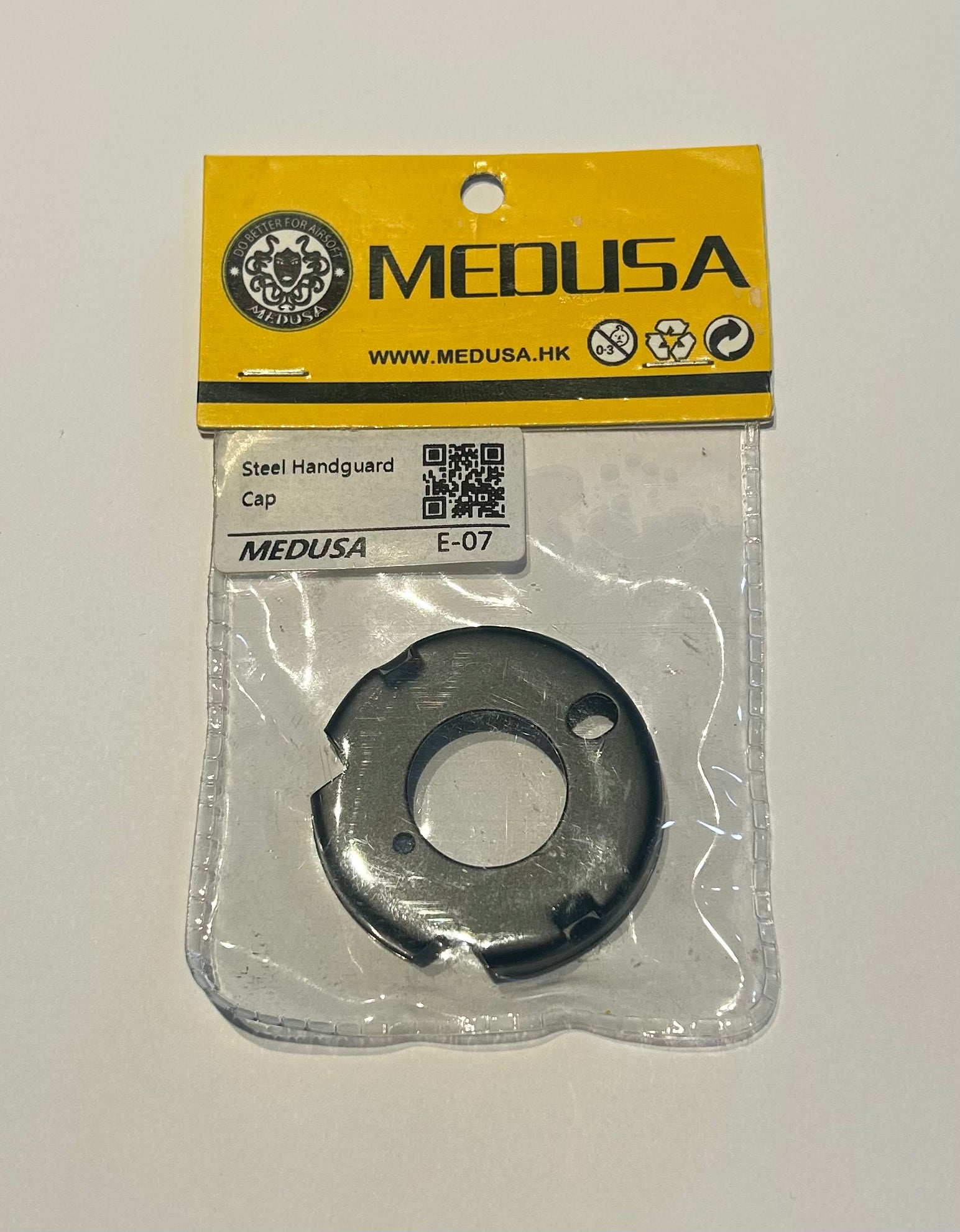 Medusa steel airsoft handguard cap in original packaging with yellow and black label