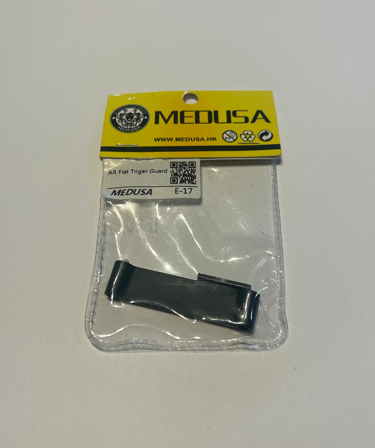 Medusa flat trigger guard ar airsoft accessory in clear packaging with yellow label