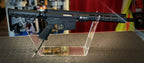DISTRICT AIRSOFT MTW billet upgrade airsoft rifle displayed on a stand with sleek design