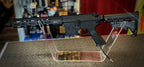 DISTRICT AIRSOFT MTW billet upgrade airsoft rifle displayed in a clear stand for showcasing features