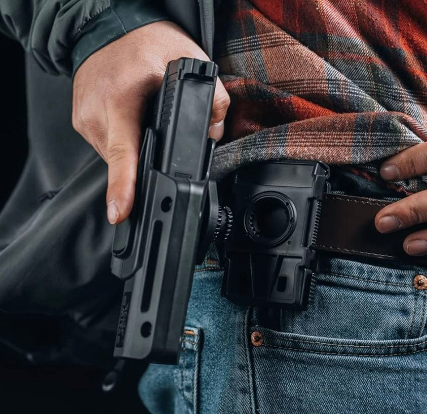 Man wearing jeans showcases a rotating holster for Glock for easy access and secure storage