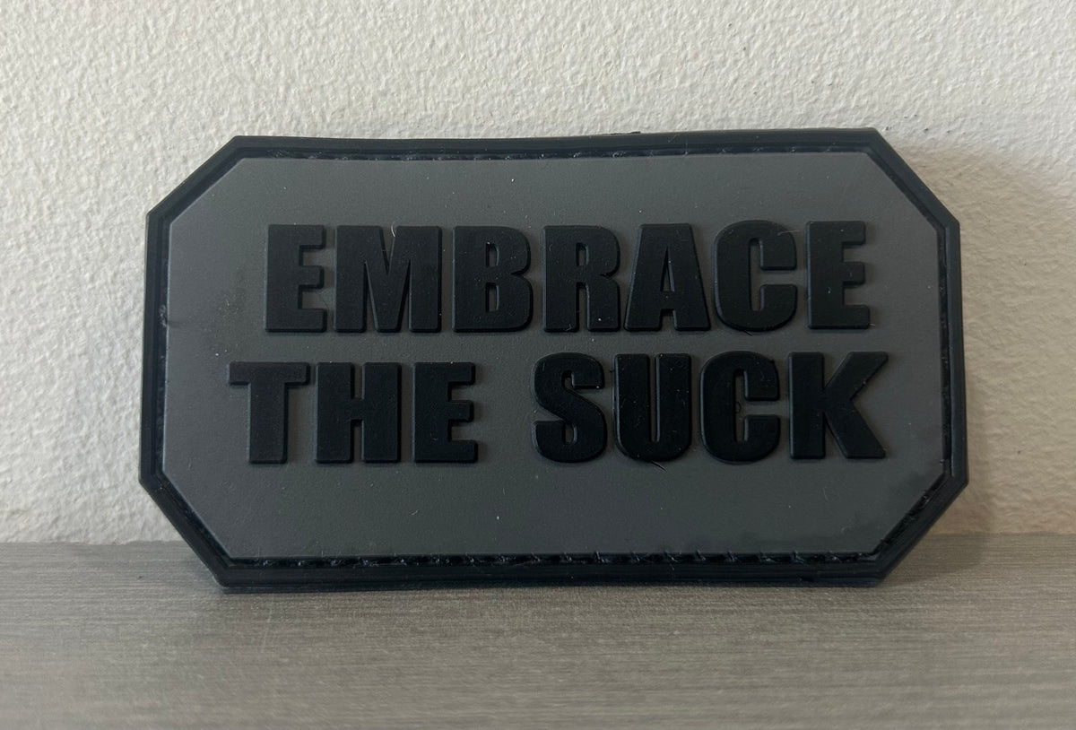 District Airsoft PATCH PVC EMBRACE THE SUCK in durable rubber for military and tactical use