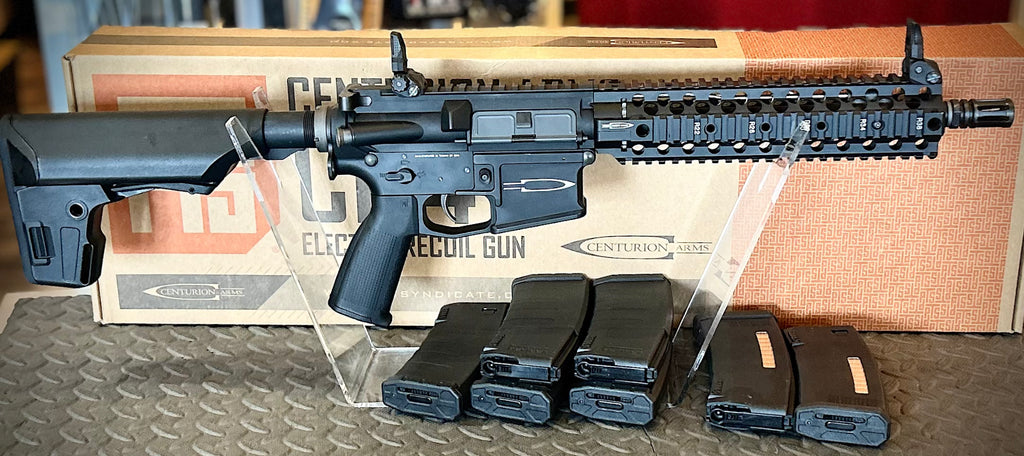 KWA PTS Centurion Airsoft Gun with Adjustable Stock and Multiple Magazines on Display