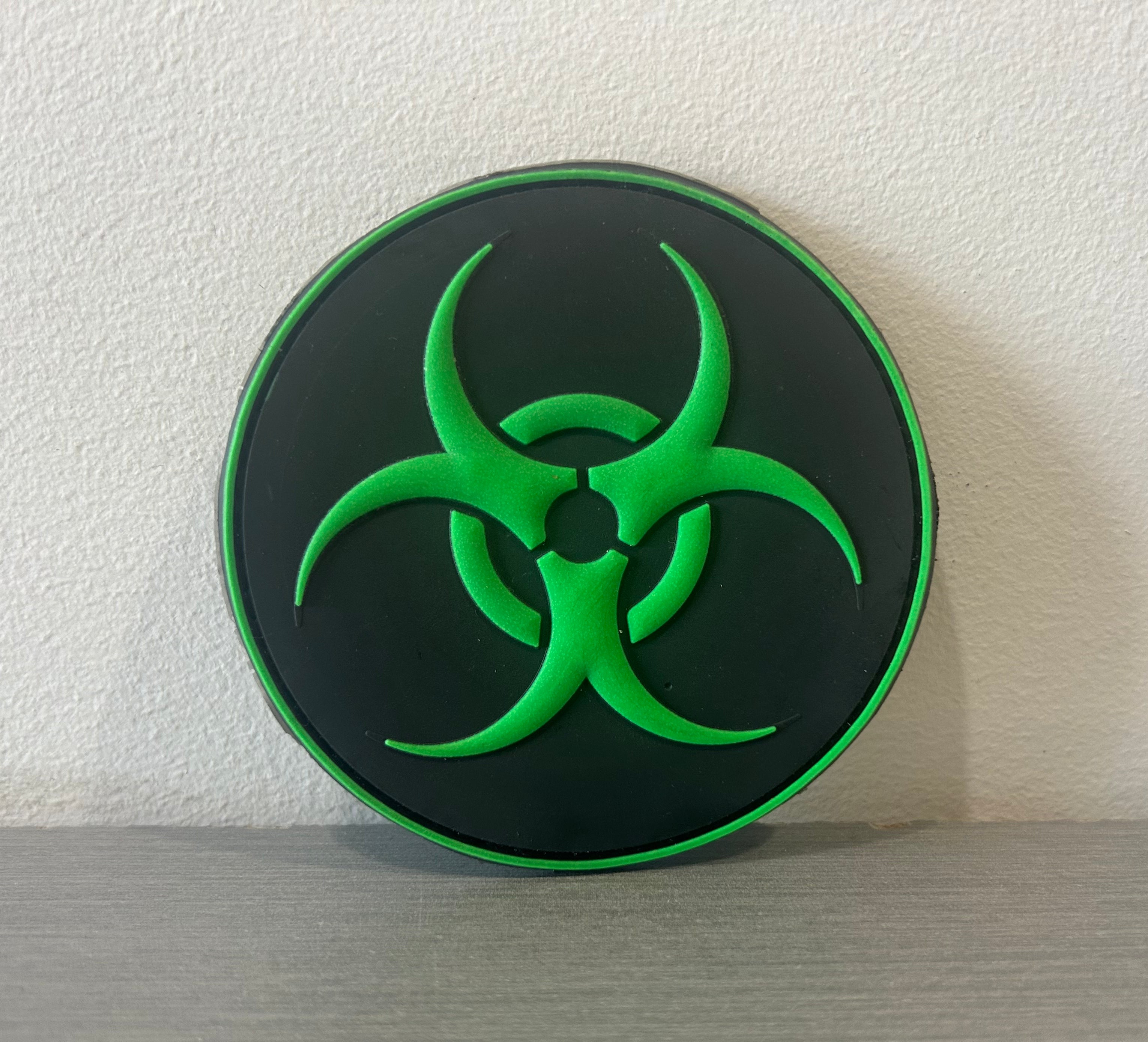 Green and black PVC patch featuring a biohazard symbol for airsoft enthusiasts