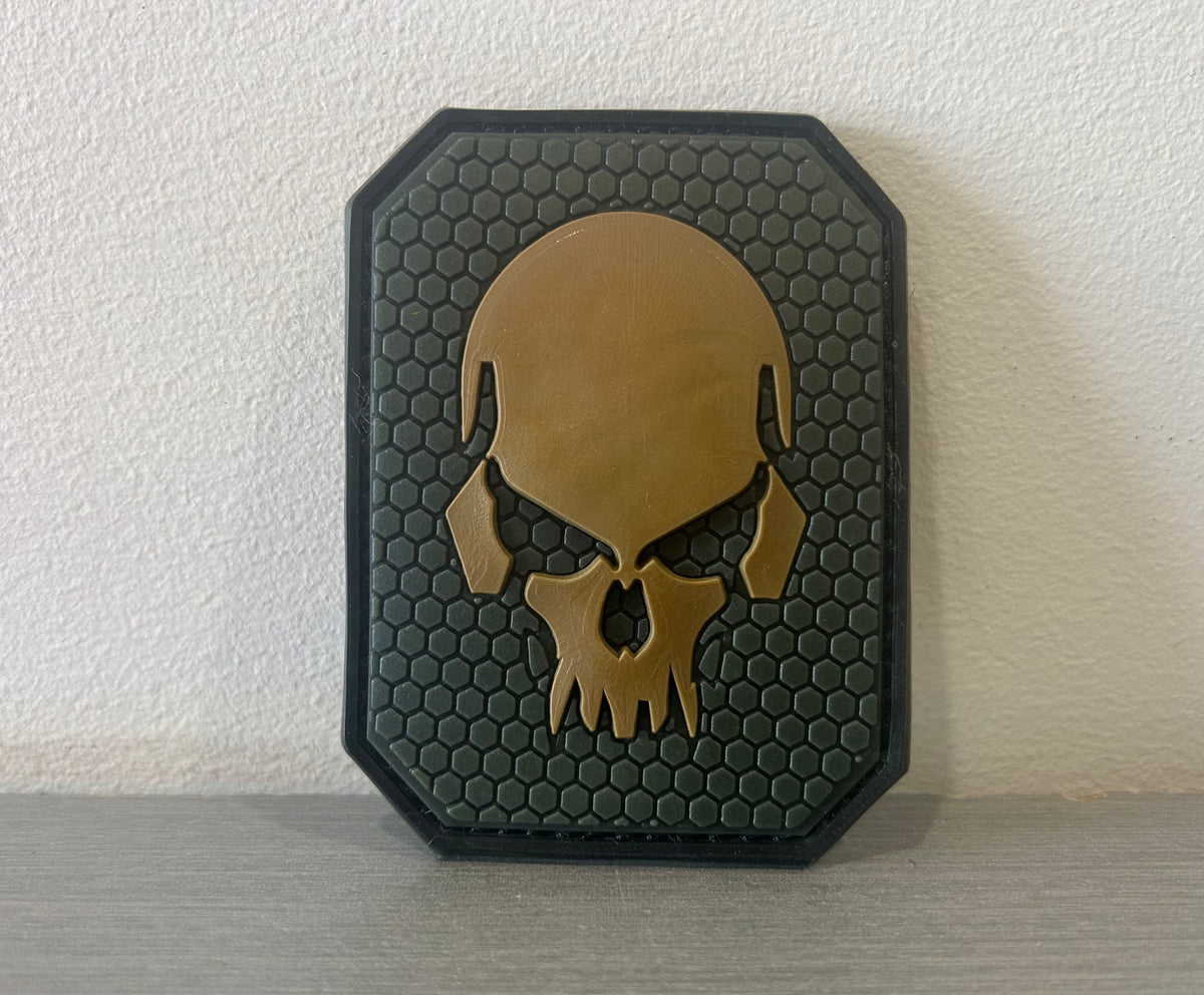 District Airsoft PVC PATCH with a skull design on a hexagonal textured background
