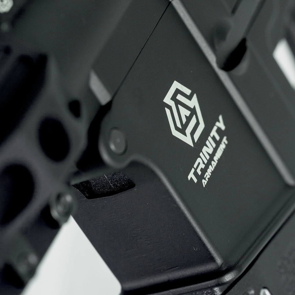 Close-up of AEG body featuring TRINITY ARMAMENT logo and detailed design elements
