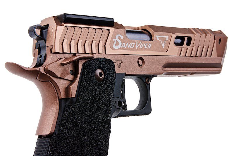 Close-up of ARMY ARMAMENT tti sand viper pistol with black textured grip and tan slide